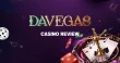 Davegas casino review banner with roulette wheel, playing cards, dice and poker chips on a dark purple casino background.
